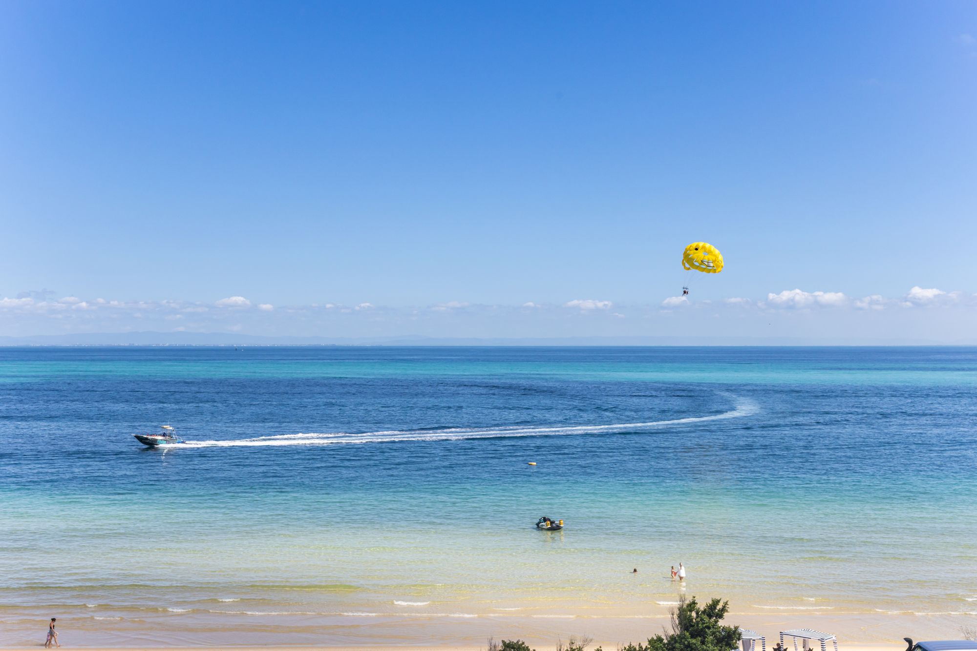 Beach with parasail offshore
