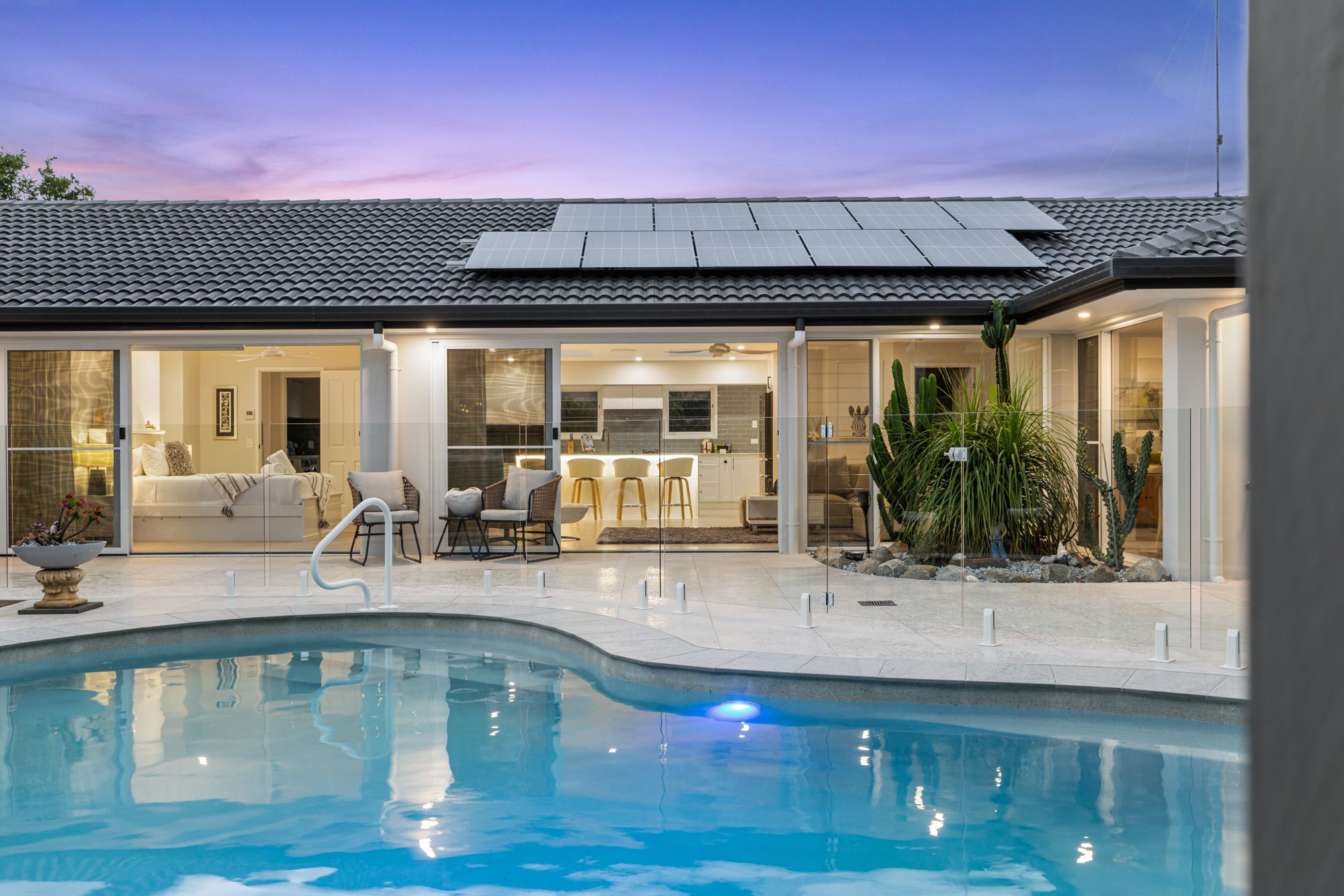 Dusk pool with home behind