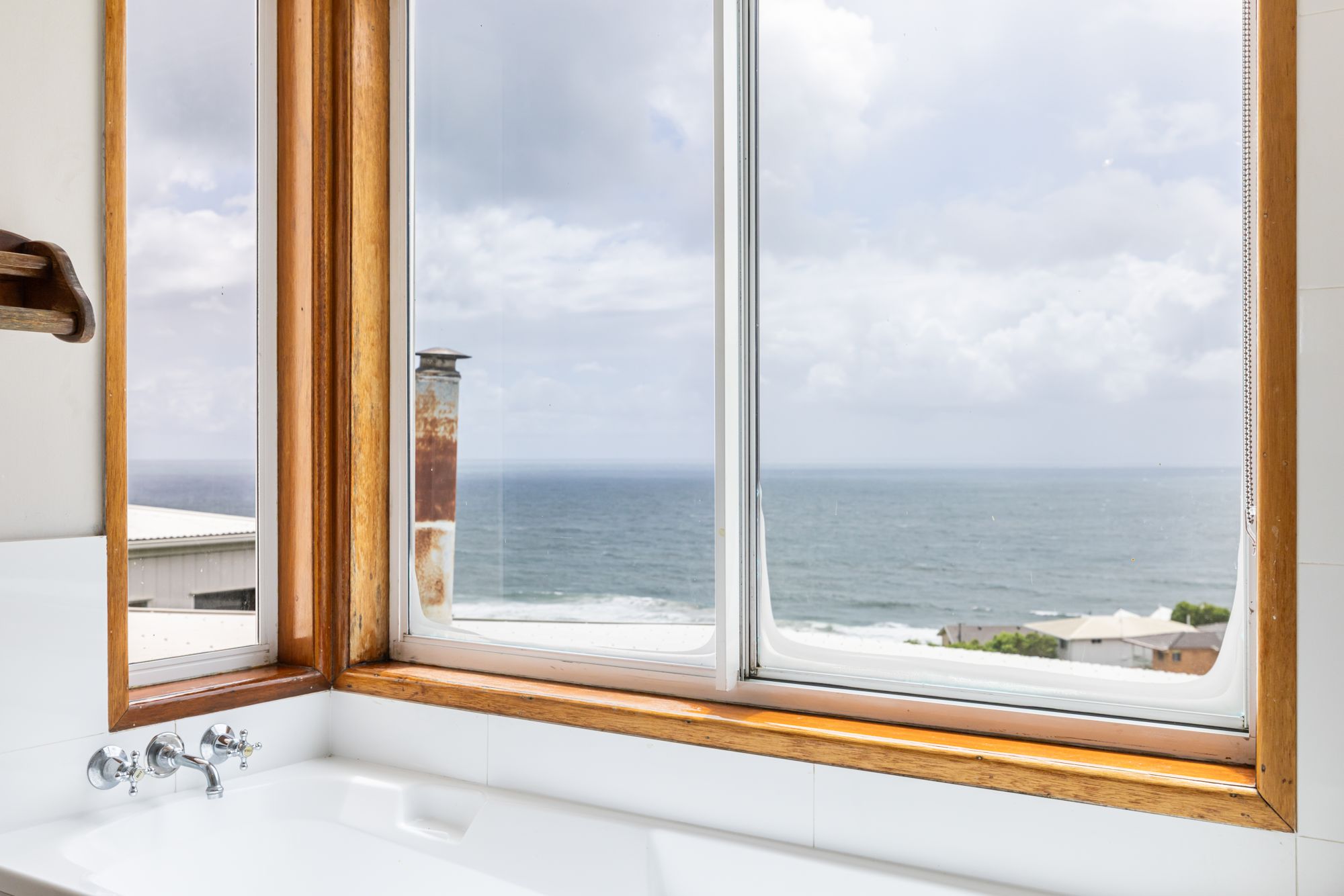 Bath beside a window with ocean view